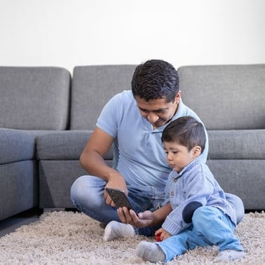 Dad and son looking at a mobile screen