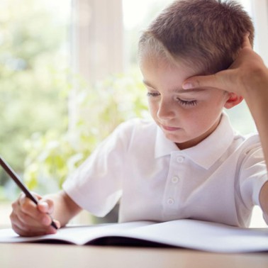 Young boy writing at a desk