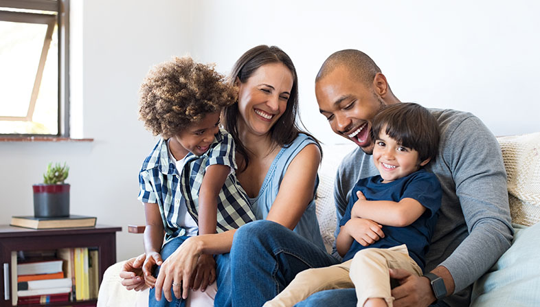 Smiling family sitting on a couch