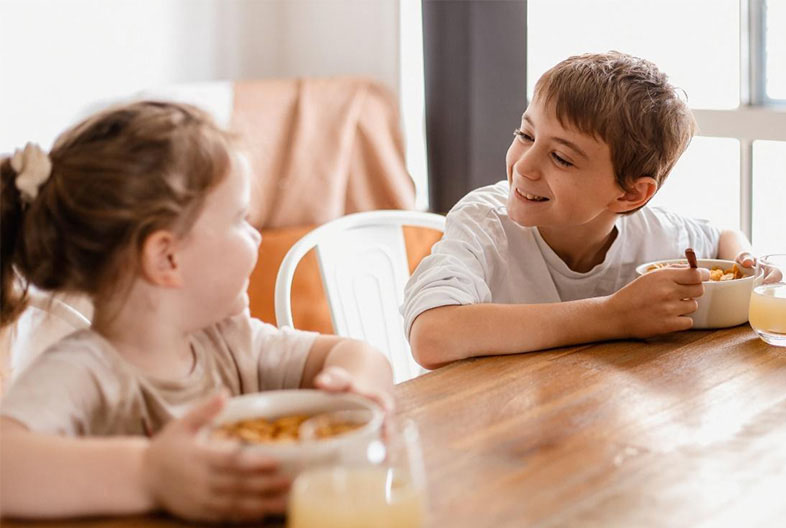 Smiling children sitting together having a meal