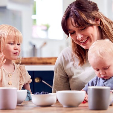 Moms having coffee with their children on their laps