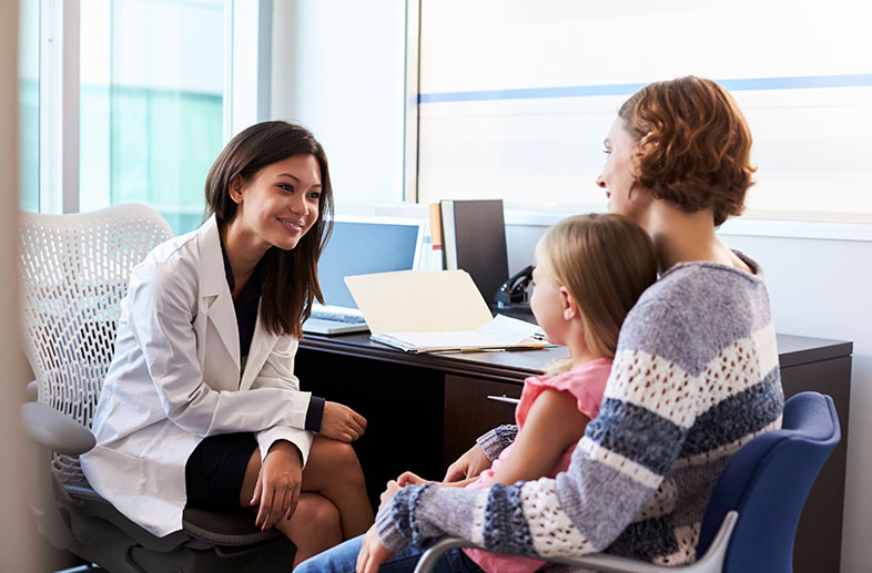 Doctor talking to mom and daughter