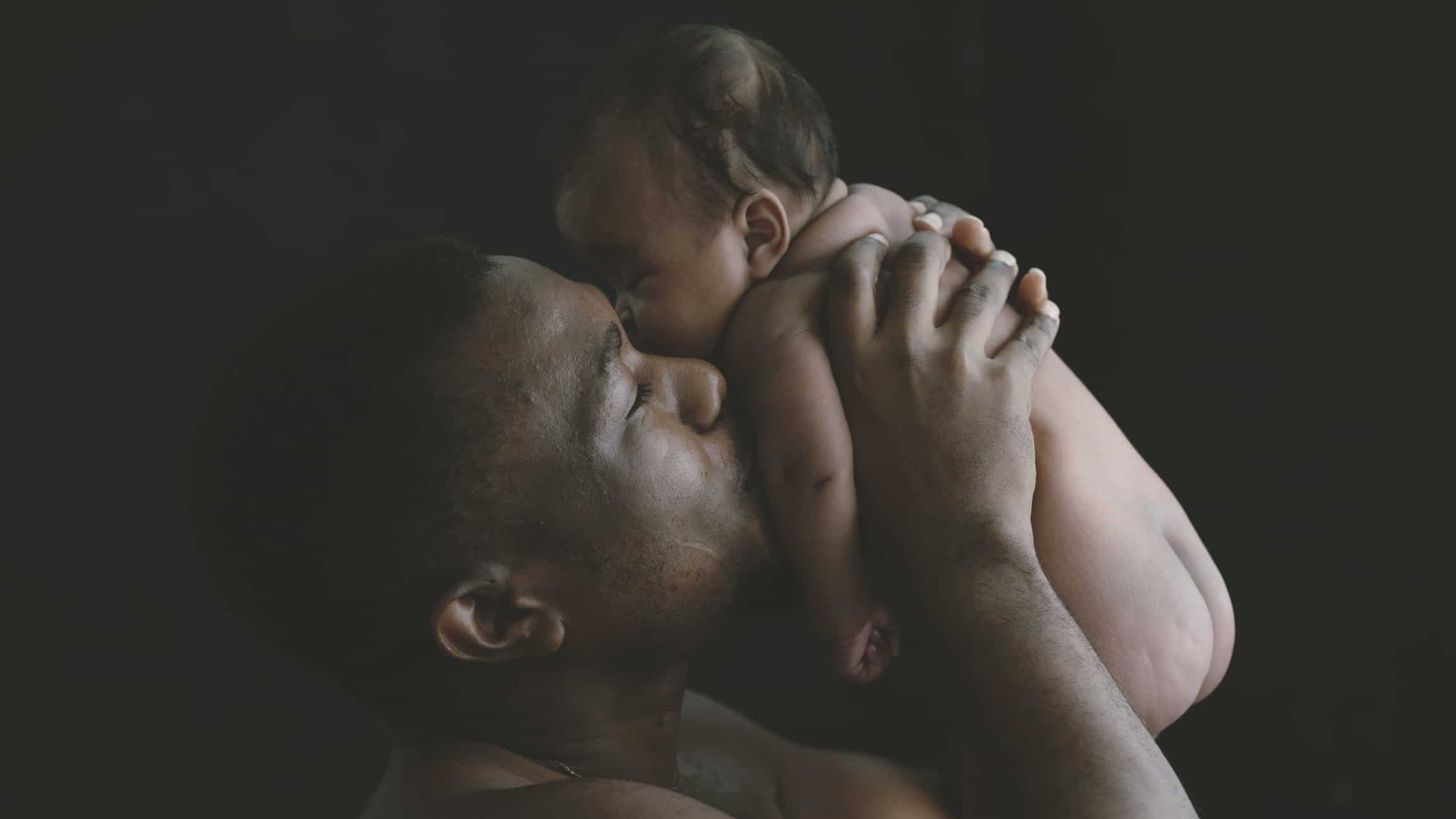 Father enjoying skin-to-skin contact with his child