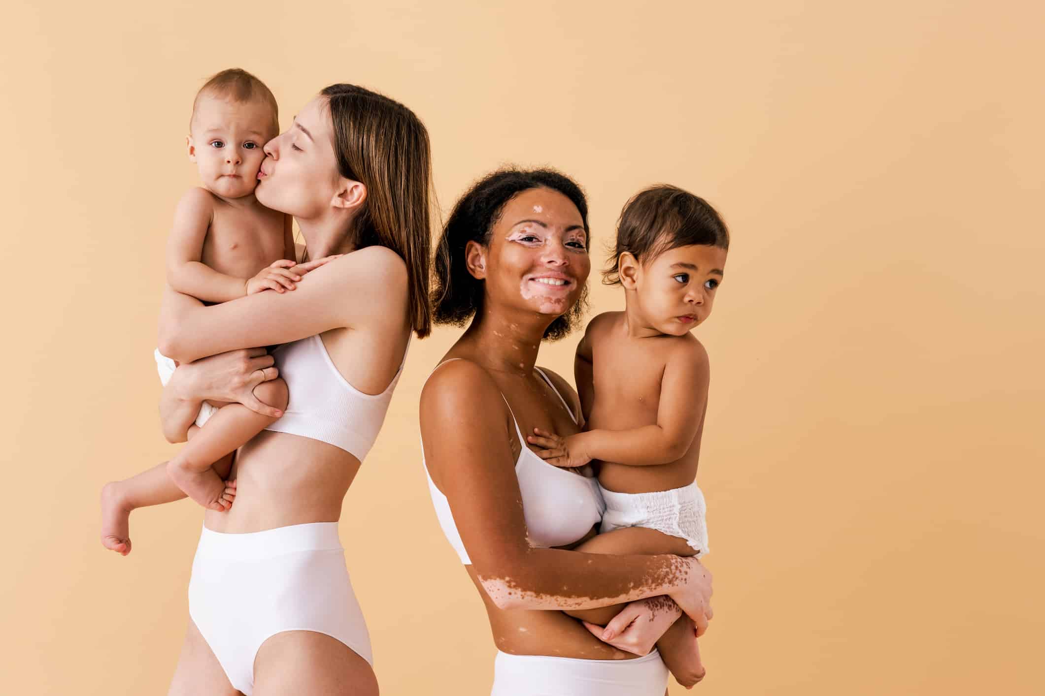 Two mothers enjoying skin-to-skin contact with their babies