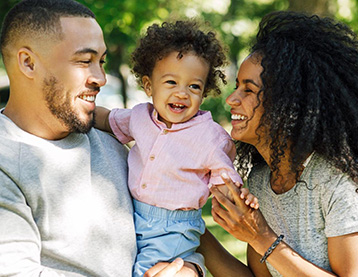 Smiling mom, dad and baby