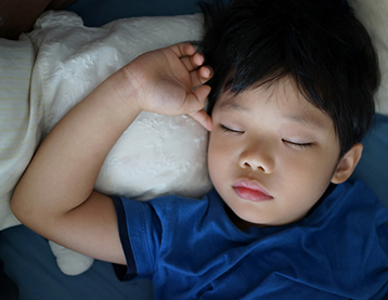 Thumbnail image of a boy sleeping peacefully in bed.