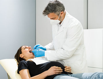 Pregnant woman at dentist appointment.